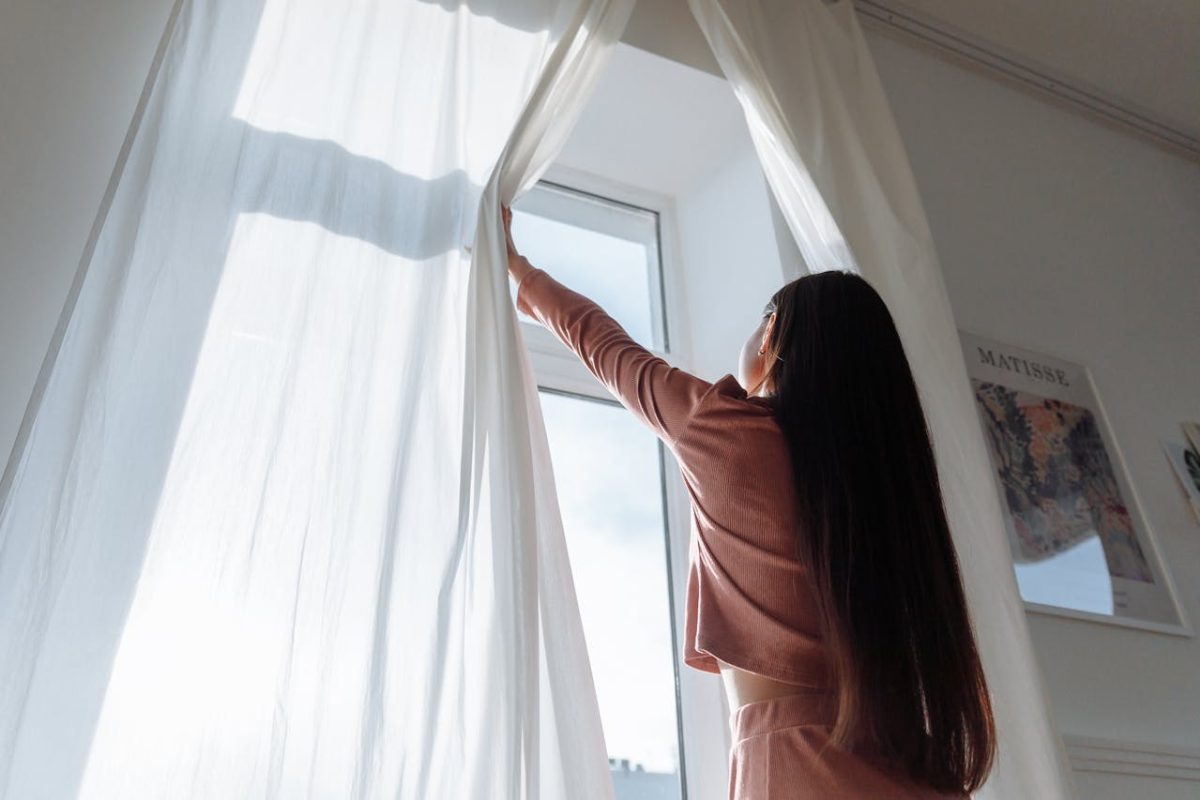 Woman Opening Curtains